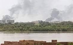 Smoke billows in the distance north of the Khartoum Bahri district amid ongoing fighting on July 14, 2023