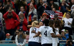 USA forward Sophia Smith is mobbed by her  teammates after scoring