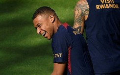 Kylian Mbappe laughs as he takes part in a training session last week