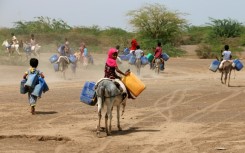 Children ride donkeys to fetch water in jerrycans at a makeshift camp for people who fled fighting between Huthi rebels and the Saudi-backed government forces, in the village of Hays in Yemen's western province of Hodeida, on July 22, 2023