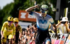 Emotional: Emma Norsgaard crosses the finish line to win stage six of the Women's Tour de France with race leader Lotte Kopecky (L) and the pack one second back