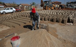 An informal brick maker works on the side of the road at the Mamelodi township.