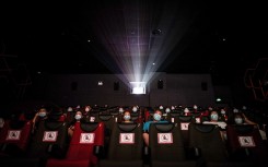 People watching a movie as they sit apart to ensure social distancing on the first day of the reopening of cinemas in China.