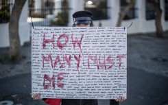 File: A woman protesting GBV. AFP/Marco Longari