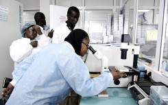 Scientific staff work in a secure laboratory, researching the coronavirus, at the Pasteur Institute in Dakar.