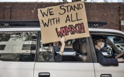 File: A woman holds a placard at a demonstration against gender-based violence in Johannesburg. AFP/Marco Longari