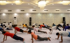 People take part in a yoga session during the International Yoga Day
