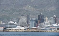 A view of cruise ships docked in the Cape Town Harbour, with the city and Table Mountain in the background .