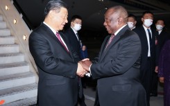 Chinese President Xi Jinping is warmly greeted by South African President Cyril Ramaphosa upon his arrival at the OR Tambo International Airport in Johannesburg, South Africa