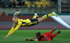 Sweden's forward  Stina Blackstenius falls to the floor