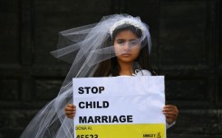 A young actress plays the role of Giorgia, 10, forced to marry Paolo, 47, during a happening organised by Amnesty International to denounce child marriage, on October 27, 2016 in Rome. 
