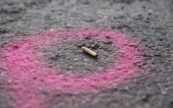 File: A spent casing is highlighted by the police at a crime scene. AFP/Guillem Sartorio