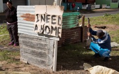 File: A sign on a shack reading "I need a home" in Woodlands, Mitchells Plain. AFP/Rodger Bosch