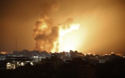 Fire and smoke rises above buildings during an Israeli air strike in Gaza City on October 8, 2023.