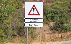 File: A sign warning motorists of a hijacking hotspot. Wikimedia Commons/Olga Ernst
