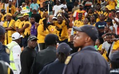 Fans react as police look on during the 2023 Carling Black Label Knockout match between Kaizer Chiefs and AmaZulu at the FNB Stadium. Muzi Ntombela/BackpagePix