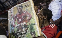 File: A fan cries holding a portrait of the slain Bafana Bafana and Orlando Pirates captain Senzo Meyiwa. AFP/Marco Longari