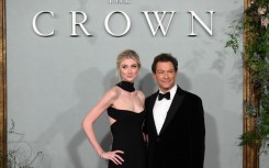 Elizabeth Debicki (L) and Dominic West pose on the red carpet upon arrival to attend the World Premiere of "The Crown. AFP/Daniel Leal