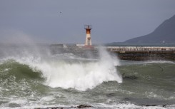 Waves spray water on structures on the seaside of Kalk Bay in Cape Town. AFP/Gianluigi Guercia