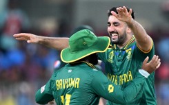 Tabraiz Shamsi celebrates with captain Temba Bavuma after taking a wicket. AFP/Satish Babu