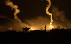 This picture taken from a position near Sderot along the Israeli border with the Gaza Strip early on November 13, 2023, shows flares dropped by Israeli forces above the Palestinian enclave amid ongoing battles between Israel and the Palestinian Hamas movement.