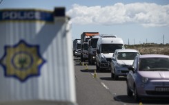 Members of the South African Police Services,the Cape Town Metro Police, and traffic officials, hold a road block on a national highway, checking whether motorists have authorisation to travel, close to Khayelitsha, near Cape Town.