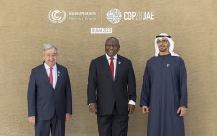 A handout picture provided by the UAE Presidential Court shows shows President of the United Arab Emirates Sheikh Mohamed bin Zayed Al Nahyan (R) and the United Nations Secretary-General Antonio Guterres (L) welcoming South Africa's President Matamela Cyril Ramaphosa prior to the opening ceremony of the COP28 Summit at Dubai's Expo City on December 1, 2023. 