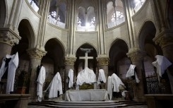 Statues protected by tarpaulins at the Notre-Dame de Paris Cathedral during its reconstruction. AFP/Pool