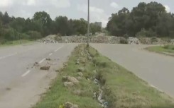 The damaged road surface. 