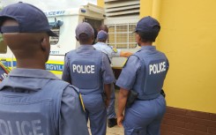 Police officers accompany the suspect to court. eNCA