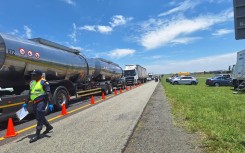 Traffic officers inspecting a vehicle. 