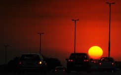 Drivers ride their cars along a highway during sunset in Johannesburg.