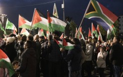 People raise Palestinian and South African flags as they celebrate a landmark "genocide" case filed by South Africa against Israel at the International Court of Justice, in the occupied West Bank city of Ramallah on January 10, 2024.