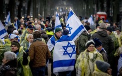 Protestors wave Israeli flags during a demonstration simultaneously at the hearing at the International Court of Justice (ICJ) on a genocide complaint by South Africa against Israel, in The Hague, January 11, 2024. 