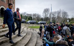 South Africa's Minister of Justice Ronald Lamola (R) exits the building to deliver remarks to journalists outside the International Court of Justice (ICJ) after the first day of hearings on the genocide case against Israel brought by South Africa, in The Hague on January 11, 2024.