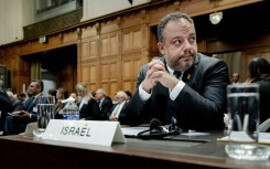 Legal Counselor of the Ministry of Foreign Affairs of Israel Tal Becker (C) looks on at the International Court of Justice (ICJ) in The Hague on January 12, 2024.