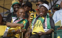 Gwede Mantashe (L), South African Minister of Mineral Resources and Energy and the chairperson of the African National Congress (ANC), South African President and president of the ANC Cyril Ramaphosa (R), react as they attend the 112th ANC Anniversary rally in Mbombela on January 13, 2024.