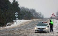 Traffic police are seen on a roadside outside the village of Yablonovo near the Russian IL-76 military transport plane crash site. AFP/Stringer