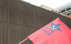 File: A flag displaying a logo of the South African Communist Party.