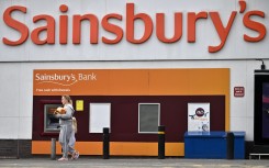 A shopper walks away from a Sainsbury's supermarket store in Tonbridge. AFP/Ben Stansall