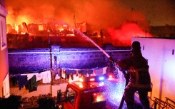 Firemen extinguish a blaze following a series of explosions in the Embakasi area of Nairobi. AFP/Simon Maina