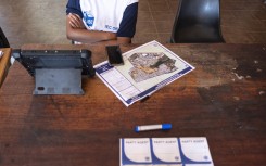 An IEC official waits for voters to be registered at a voting station. AFP/Emmanuel Croset