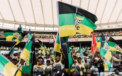 Supporters of the African National Congress (ANC) wave flags during the Election Manifesto launch. AFP/Rajesh Jantilal
