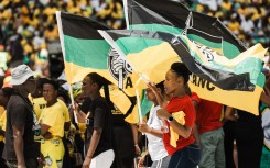 Supporters display ANC flags during the Election Manifesto launch. AFP/Rajesh Jantilal