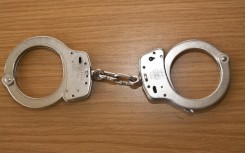File: A pair of handcuffs on a table. Rolf Kremming/dpa Picture-Alliance via AFP