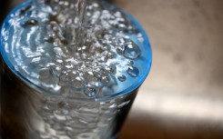 File:  Tap water flows into a glass.  