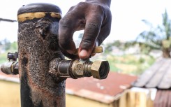 A person opens the tap. AFP