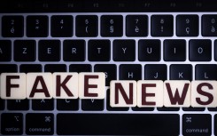 File: This illustration photograph shows letters reading "fake news", against a laptop keyboard. AFP/Sebastien Bozon