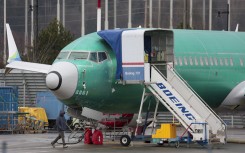 A person walks past a Boeing 737-8 MAX parked in production at Renton Municipal Airport. AFP/Jason Redmond