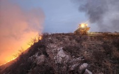A Texas A&M Forest Service bulldozer building a containment line as it battles the Windy Deuce Fire in Moore County, Texas. AFP